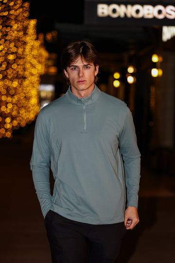 Man Wearing Green Q Zip