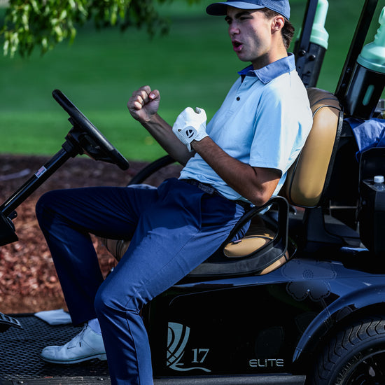 Man sitting in a golf cart on a golf course