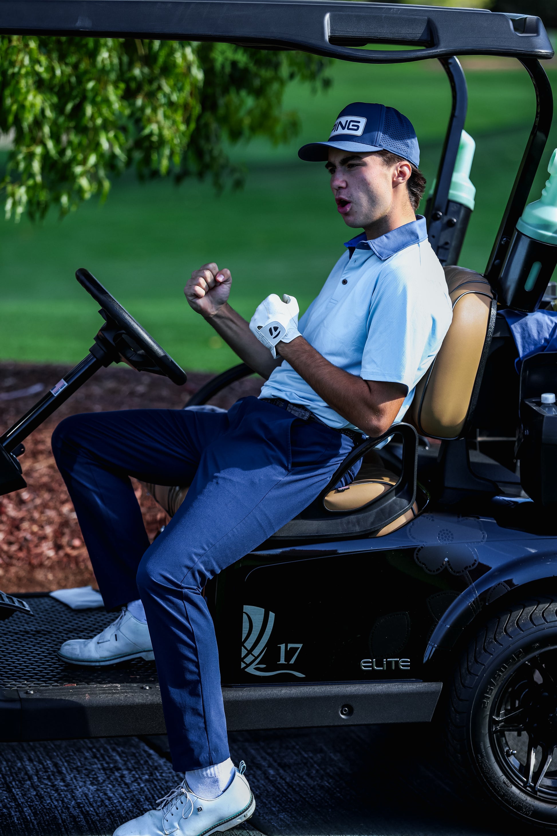 Man sitting in a golf cart on a golf course